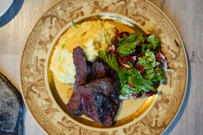 Appetizing beef with mashed potatoes and herbs