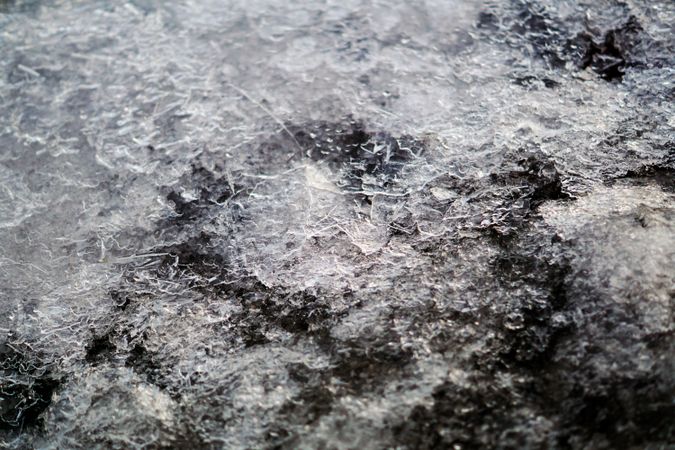 Melted snow crust over rocks