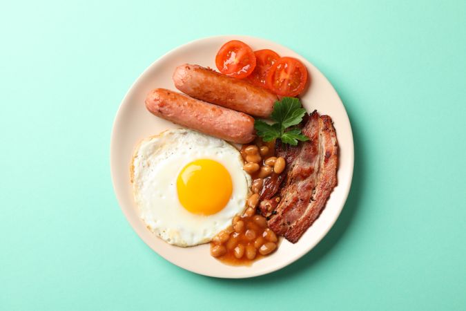 Top view of breakfast plate on green background