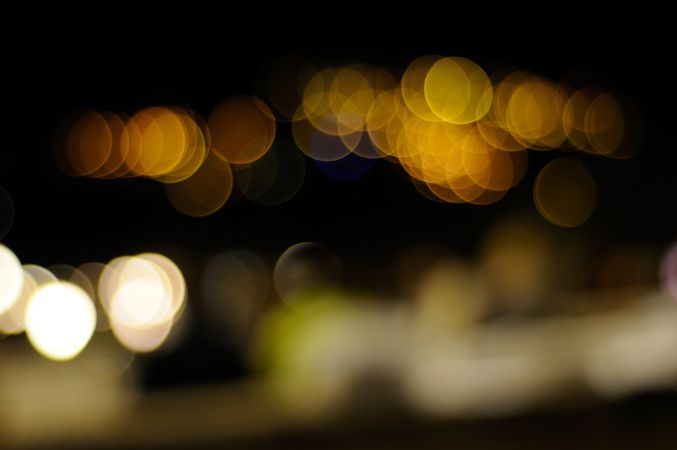 Golden night lights, blurry along city street