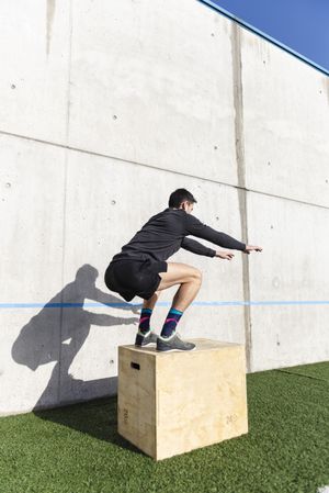 Man training on sports ground near wall