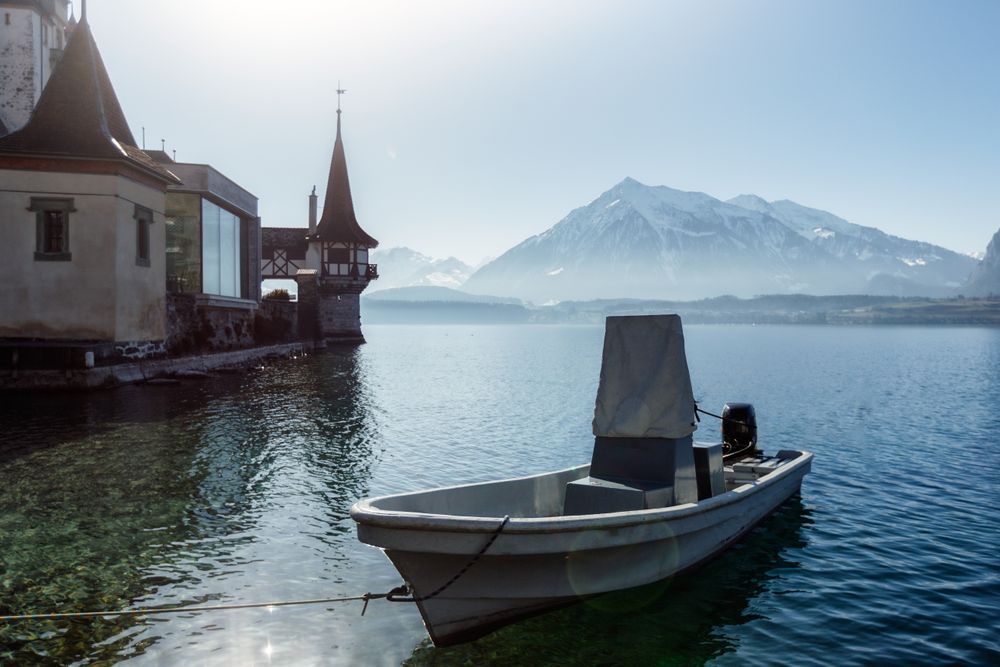 Boat at pier on lake in mountain landscape