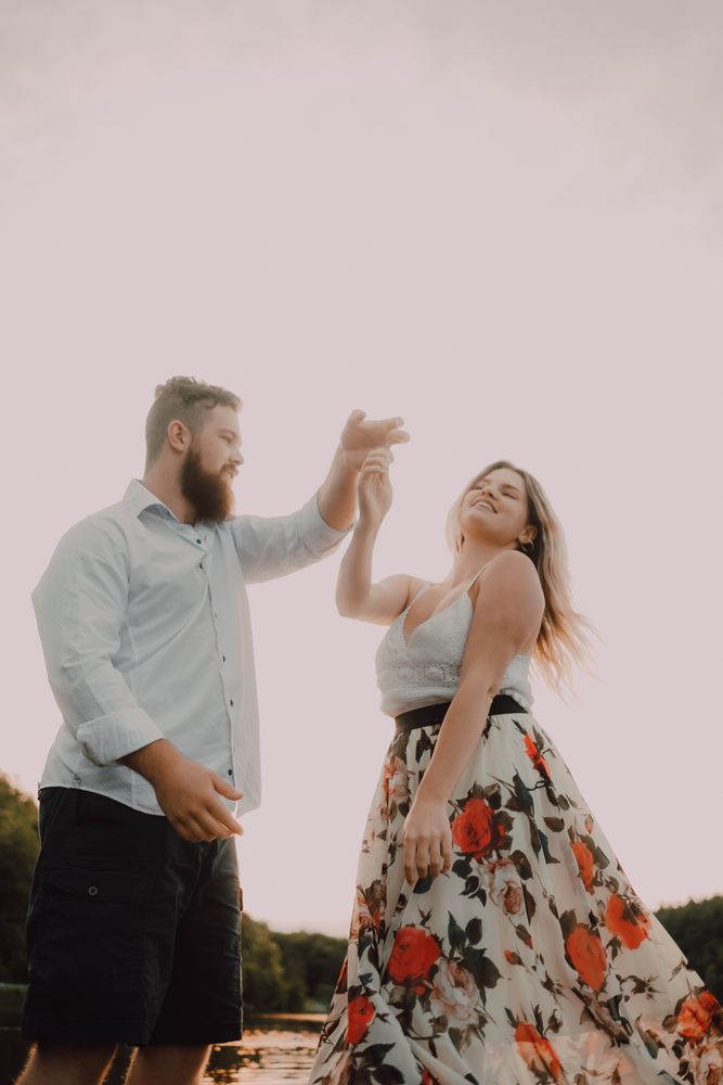 Loving couple standing ankle deep in water on beach