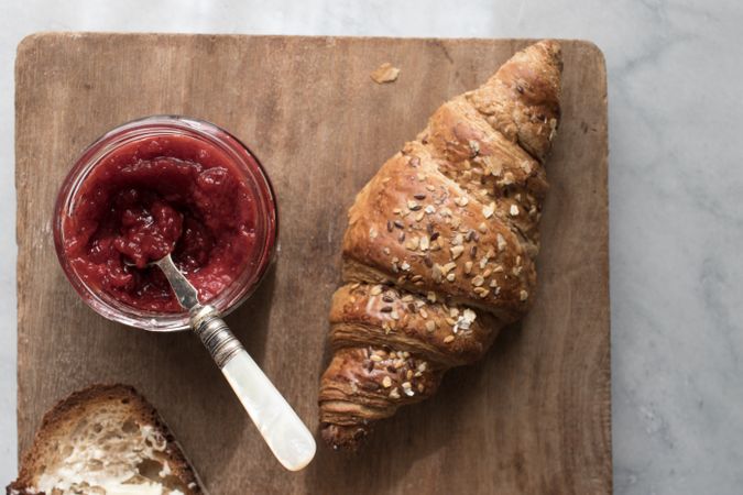 Served breakfast meal with croissant and jam