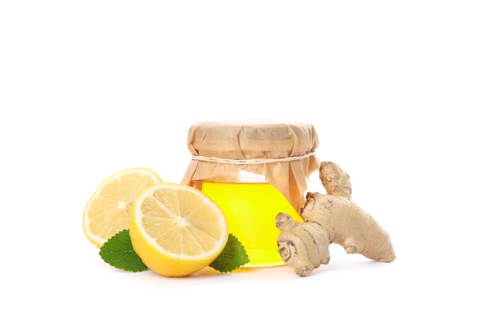 Ginger, lemons and glass jar with honey isolated on neutral background