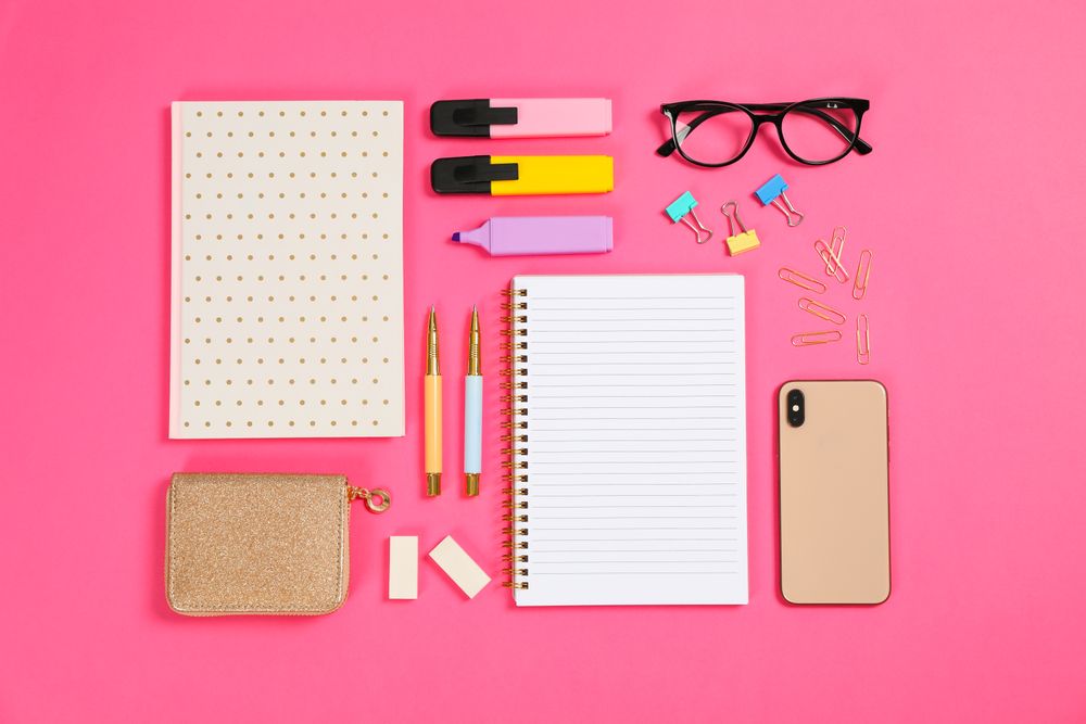 Flat lay composition with stationery on pink background, space for text