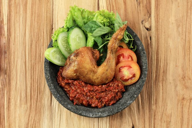 Top view of fried chicken Indonesian dish served with sambal paste