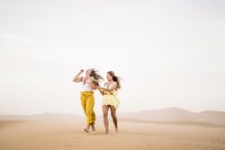 Happy women walking in the desert in desert