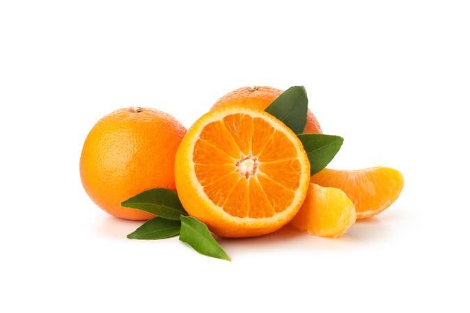 Group of ripe mandarins isolated on light background