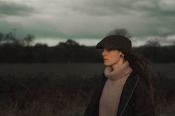 Young woman in warm clothes in forest
