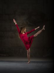 Young woman with upped leg in darkness