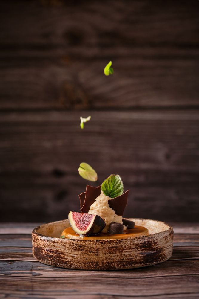Decorating of cheesecake with mint leaves