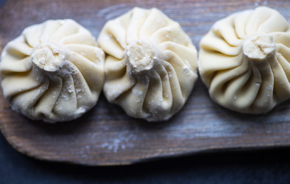 Top view of traditional Georgian khinkali dumplings served on wooden board