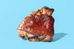 Roasted pork knuckle minimalist on a blue background