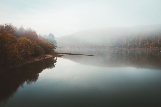 Tranquil water of lake in mist