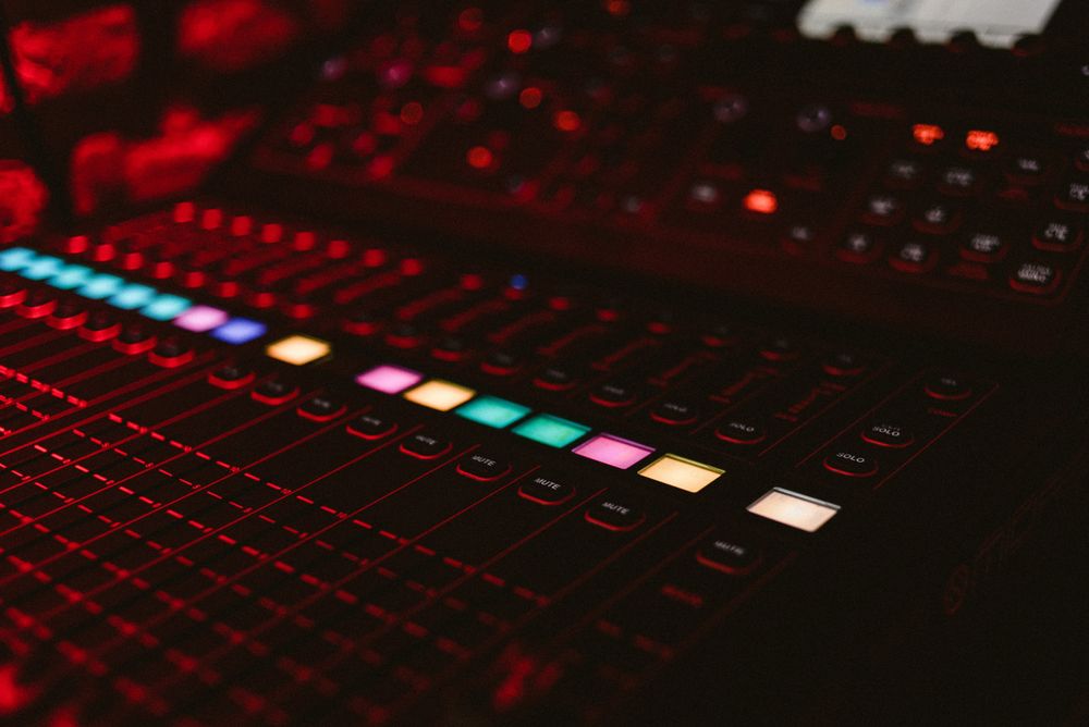 DJ music board with light buttons in club