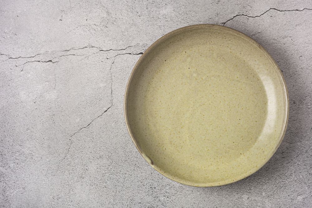 Empty plate on the slate table. Top view of the image.