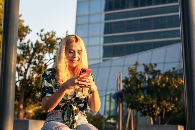 Blonde women using mobile phone outdoors