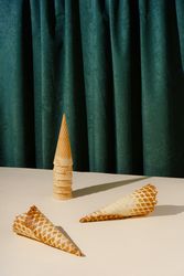 Waffle cones in front of green curtain background