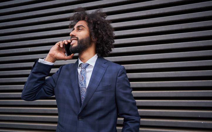 man taking phone near wall