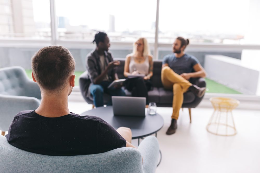 Colleagues having a discussion in a bright modern office