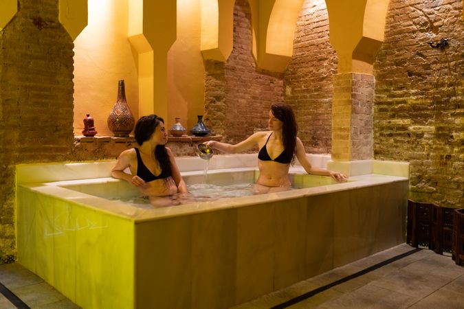 Friends enjoying luxurious baths in spa
