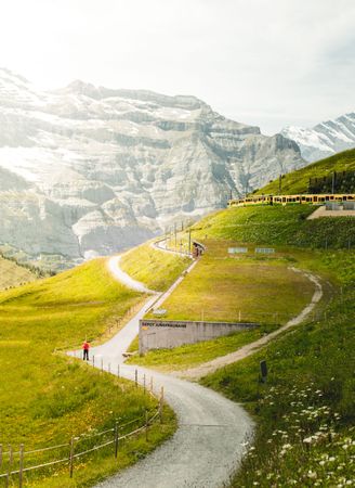 Person walking on path near mountain side