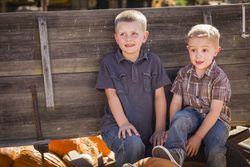 Two Boys Having Fun at the Pumpkin Patch