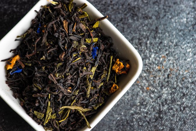 Fragrant loose leaf tea in bowl on counter