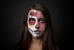Young woman with creepy face paint