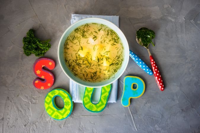 Bowl of healthy chicken soup on napkin with garnish