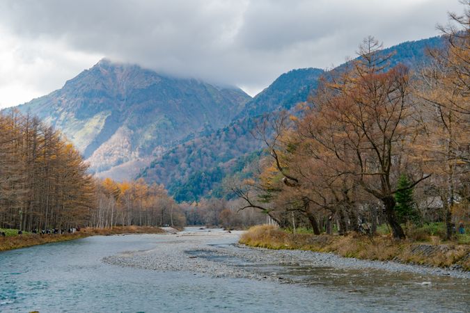 landscape view of japan alps mountain with natural forest, blue river on autumn season at kamikochi Nagano.