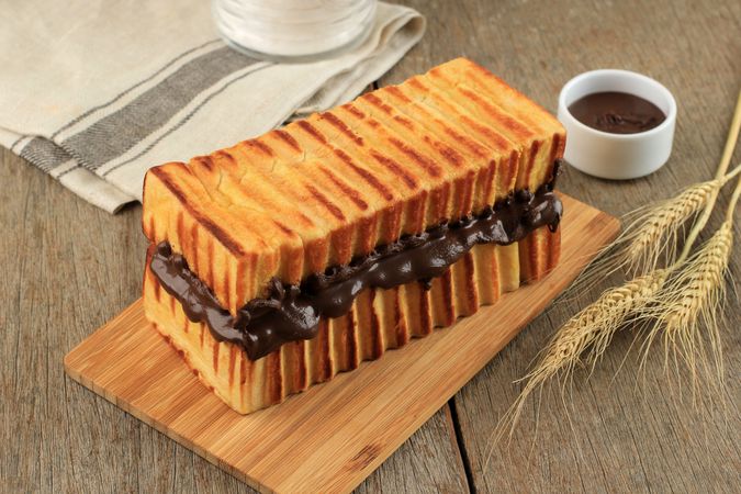 Toasted bread with delicious chocolate spread filling  on breadboard