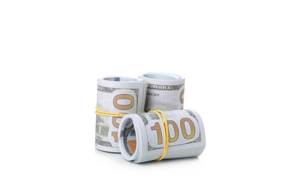 Rolls of Dollar bills isolated on light background