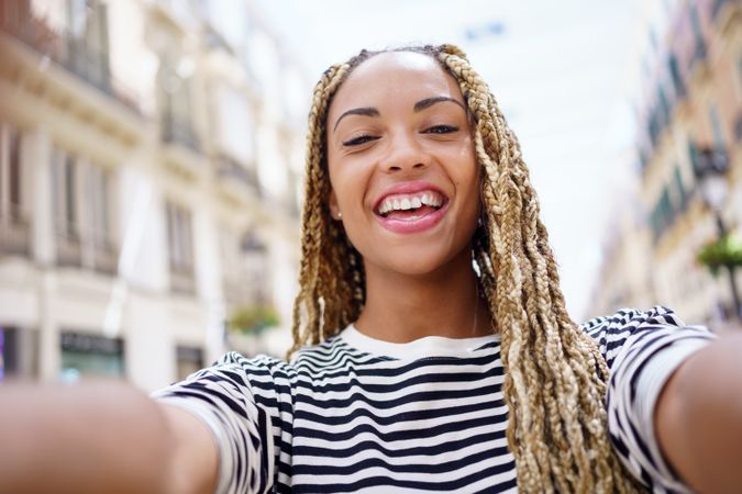 POV view of smiling woman taking selfie