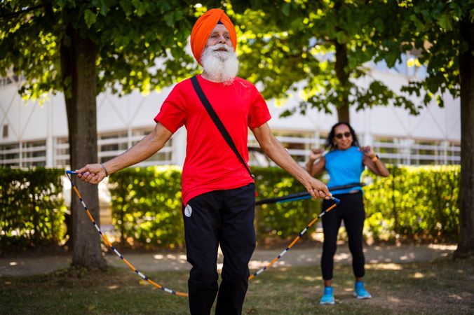 Mature Sikh couple exercising outside