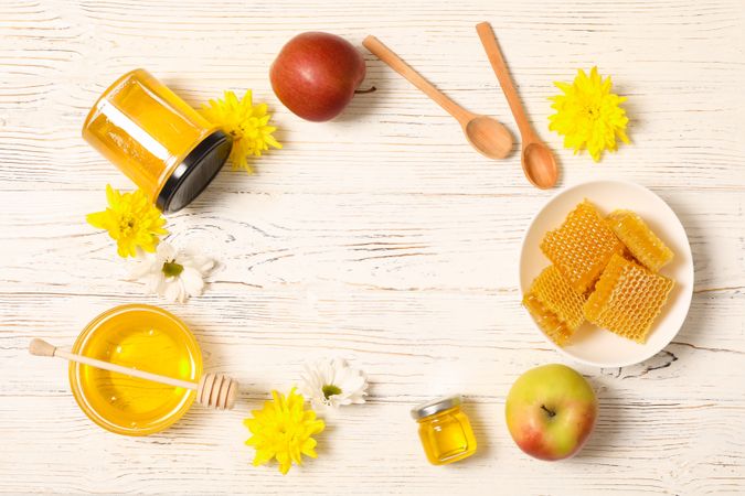 Honey, flowers and apples on wooden background, copy space