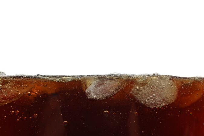 Side view background of cold cola with ice, isolated