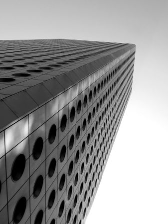 Low-angle view of a skyscraper in grayscale