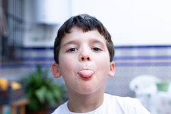 Boy showing tongue for camera