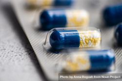 Close up of blue pills on grey counter 0yXlVa