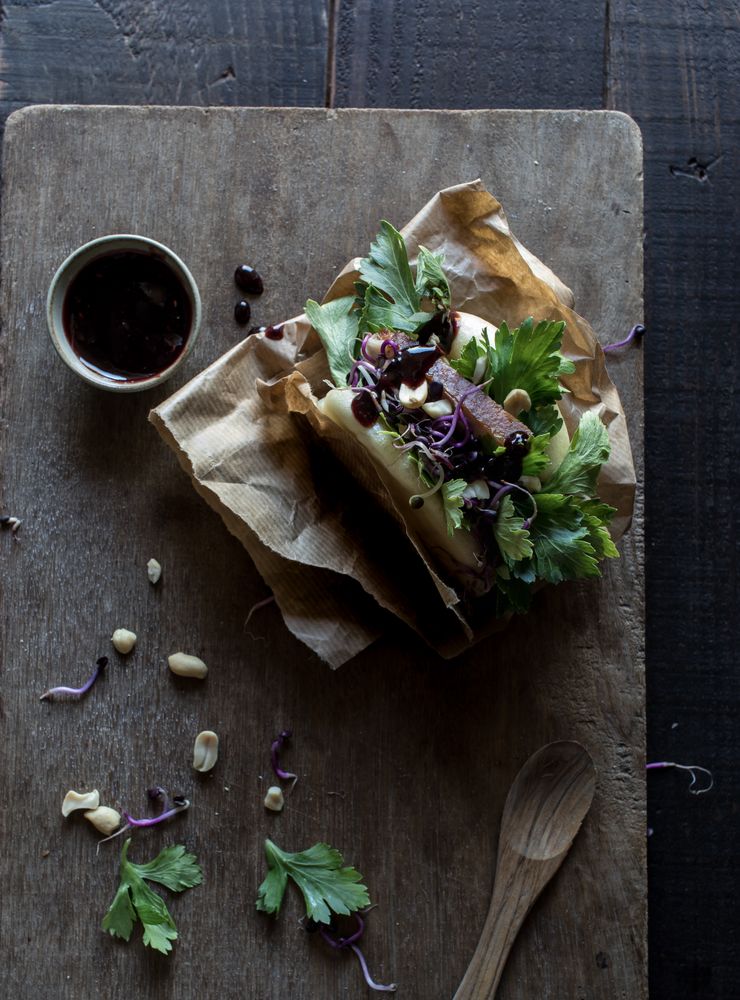 Served Gua Bao sandwich with sauce on board