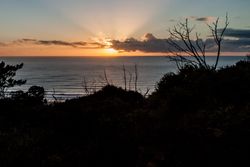 Beautiful sunset looking at ocean from hill