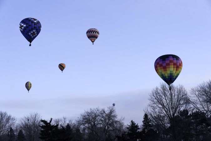 Hudson, WI, USA - February 8th, 2020: A sky with suspended colorful hot air balloons