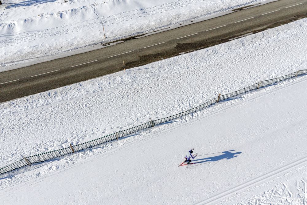 Skier running on the track. Snow field. Aerial.