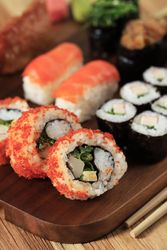 Colorful California rolls on wooden tray