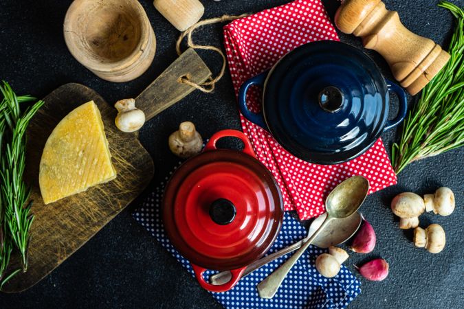 Top view of two red & blue cast iron pan on kitchen counter with ingredients