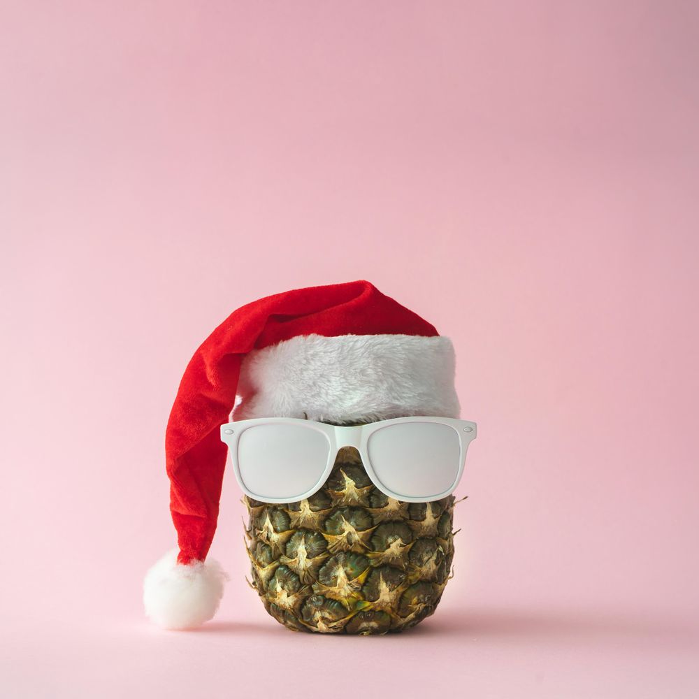 Santa Claus face made with pineapple and light painted sunglasses