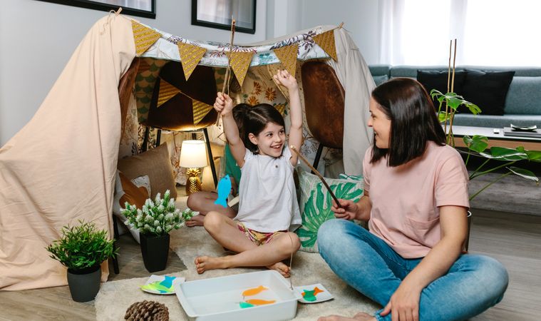 Girl happy to win her mother in a fishing game