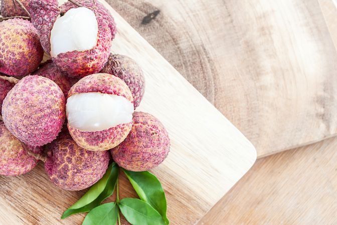 Closeup of lychee fruits on wooden board, fruits of asian